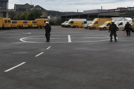 Die Polizei bewacht den Parkplatz der Post und sagt, dass dieses Privatgelände sei. (die Neonazis befinden sich irgendwo dahinter)